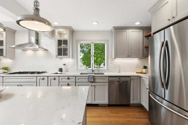 11 Williams St, Arlington, MA 02476 - kitchen with appliances with stainless steel finishes, open shelves, wall chimney exhaust hood, decorative backsplash, and glass insert cabinets