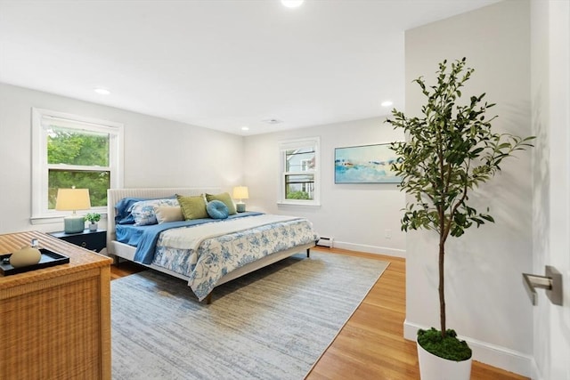 11 Williams St, Arlington, MA 02476 - bedroom featuring multiple windows, a baseboard radiator, light wood finished floors, and recessed lighting