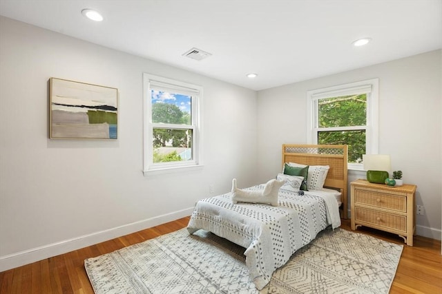 11 Williams St, Arlington, MA 02476 - bedroom featuring multiple windows, wood finished floors, and recessed lighting