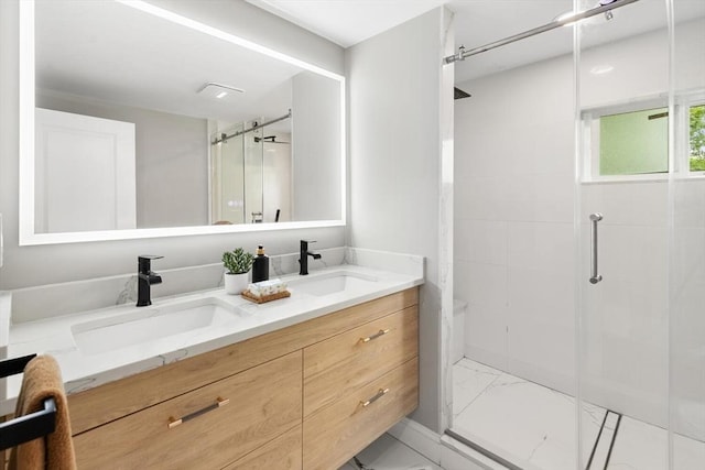 11 Williams St, Arlington, MA 02476 - bathroom featuring marble finish flooring, a stall shower, and double vanity