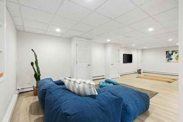 11 Williams St, Arlington, MA 02476 - living room with wood finished floors, a baseboard radiator, a baseboard heating unit, and a paneled ceiling