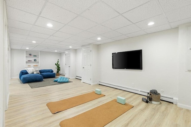 11 Williams St, Arlington, MA 02476 - workout area with wood finished floors, recessed lighting, a paneled ceiling, and a baseboard radiator