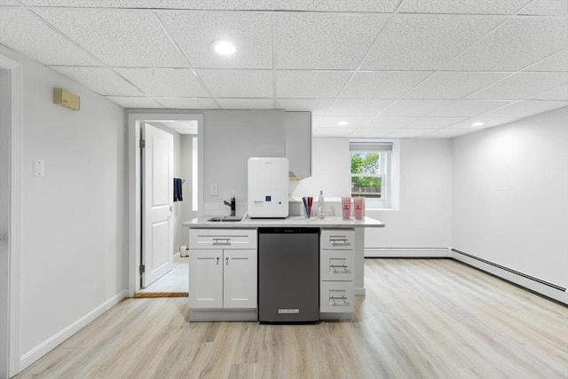 11 Williams St, Arlington, MA 02476 - kitchen featuring light wood-type flooring, light countertops, fridge, white cabinets, and a paneled ceiling