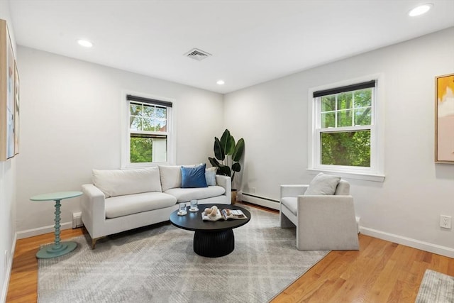 11 Williams St, Arlington, MA 02476 - living room with baseboard heating, plenty of natural light, light wood-type flooring, and recessed lighting