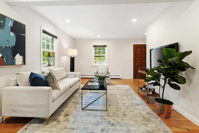 11 Williams St, Arlington, MA 02476 - living area featuring a baseboard radiator, plenty of natural light, wood finished floors, and recessed lighting