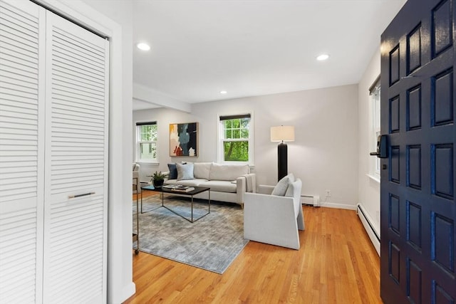 11 Williams St, Arlington, MA 02476 - living room with a baseboard heating unit, light wood-type flooring, and recessed lighting