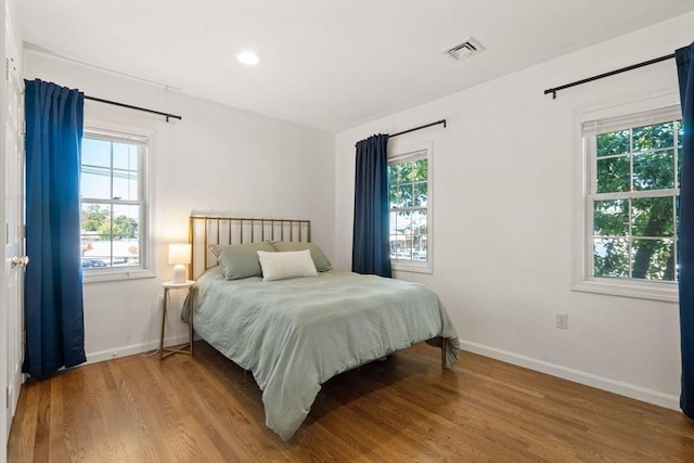 bedroom featuring visible vents, recessed lighting, wood finished floors, and baseboards