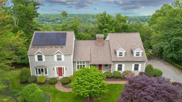 161 Old Farm Rd, Leominster, MA 01453 - view of front of home featuring solar panels, a view of trees, a chimney, and a shingled roof