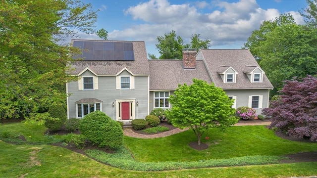 161 Old Farm Rd, Leominster, MA 01453 - view of front of property featuring a front lawn, roof mounted solar panels, a shingled roof, and a chimney