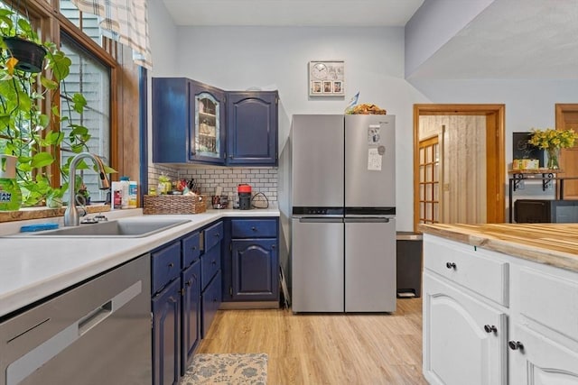 161 Old Farm Rd, Leominster, MA 01453 - kitchen with appliances with stainless steel finishes, a sink, light countertops, light wood-type flooring, and blue cabinetry