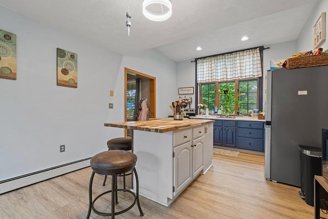 161 Old Farm Rd, Leominster, MA 01453 - kitchen featuring freestanding refrigerator, butcher block counters, light wood-style flooring, a breakfast bar, and baseboard heating