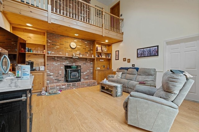 161 Old Farm Rd, Leominster, MA 01453 - living room with light wood-style flooring, a wood stove, and a towering ceiling