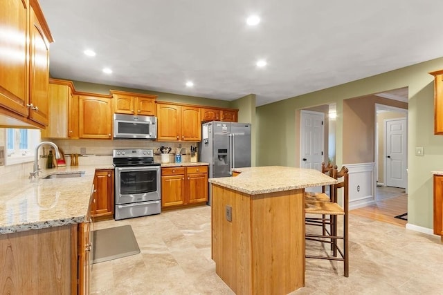 19 Miele Rd, Marlborough, MA 01752 - kitchen featuring stainless steel appliances, a sink, a kitchen breakfast bar, a center island, and light stone counters