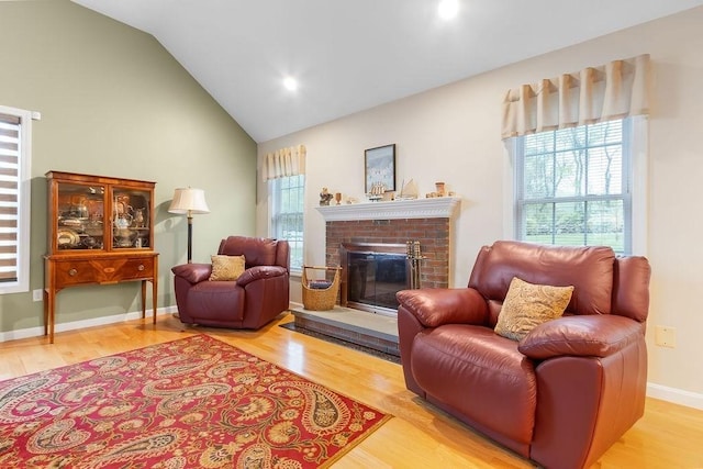 19 Miele Rd, Marlborough, MA 01752 - sitting room with healthy amount of natural light, wood finished floors, a brick fireplace, high vaulted ceiling, and recessed lighting
