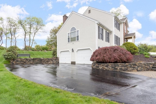 19 Miele Rd, Marlborough, MA 01752 - view of home's exterior featuring asphalt driveway, a chimney, and a garage