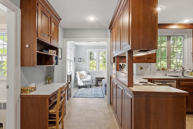 79 Cheever Cir, Andover, MA 01810 - kitchen featuring a sink, light countertops, brown cabinetry, light floors, and a peninsula