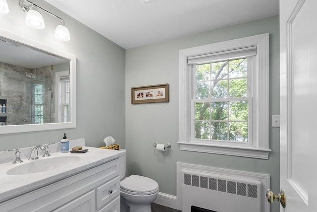79 Cheever Cir, Andover, MA 01810 - full bathroom with radiator, vanity, toilet, tiled shower, and baseboards