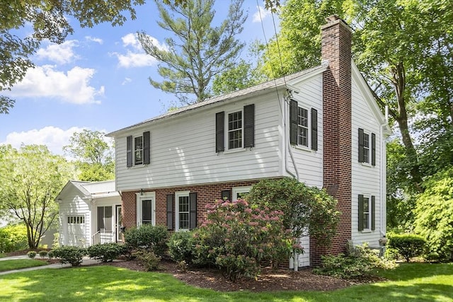 79 Cheever Cir, Andover, MA 01810 - colonial home featuring a chimney, an attached garage, a front yard, and brick siding