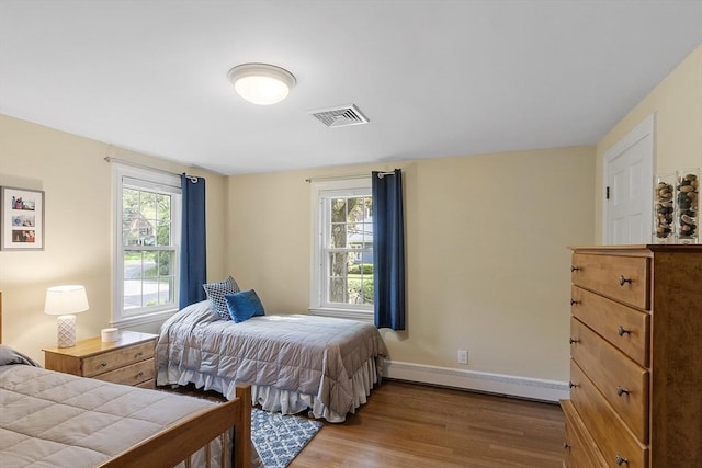 79 Cheever Cir, Andover, MA 01810 - bedroom with wood finished floors, a baseboard heating unit, and baseboards