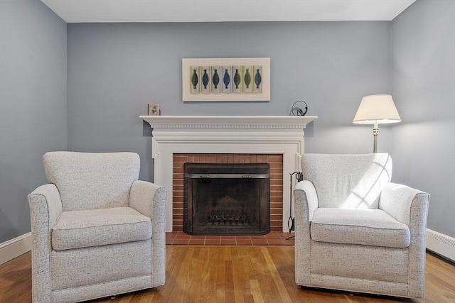 79 Cheever Cir, Andover, MA 01810 - sitting room featuring wood finished floors, a brick fireplace, and baseboards