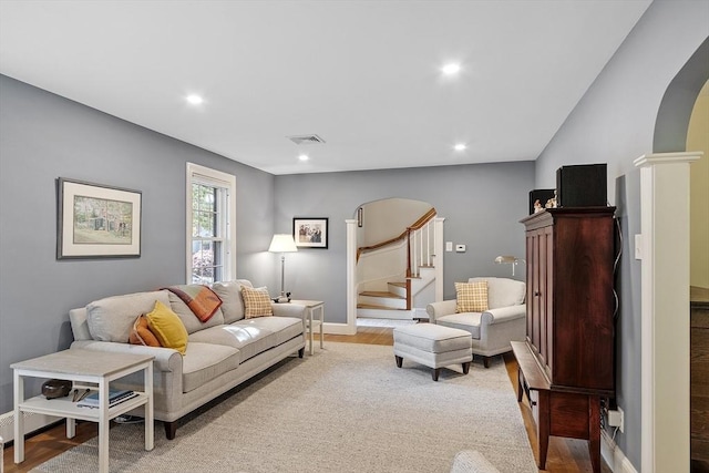 79 Cheever Cir, Andover, MA 01810 - living area with arched walkways, stairs, wood finished floors, recessed lighting, and baseboards