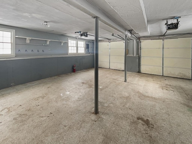 parking garage with electric panel and a garage door opener