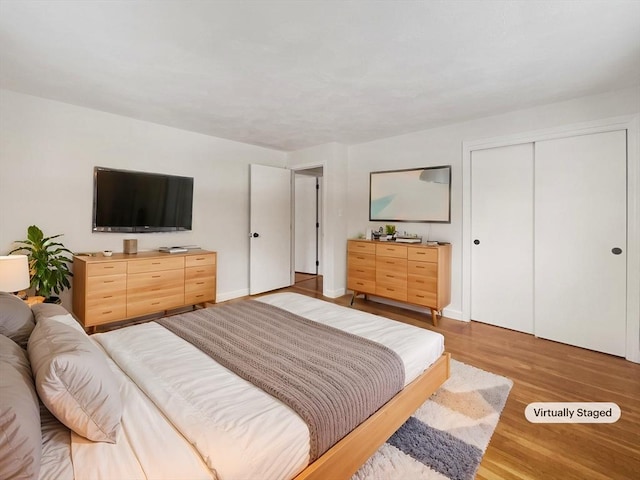 bedroom with a closet and wood finished floors