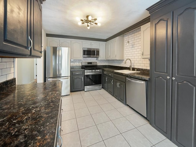 kitchen with tasteful backsplash, stainless steel appliances, a sink, and light tile patterned flooring