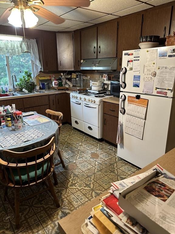 9 Coburn Ave, Worcester, MA 01604 - kitchen featuring white appliances, under cabinet range hood, a ceiling fan, a sink, and a drop ceiling