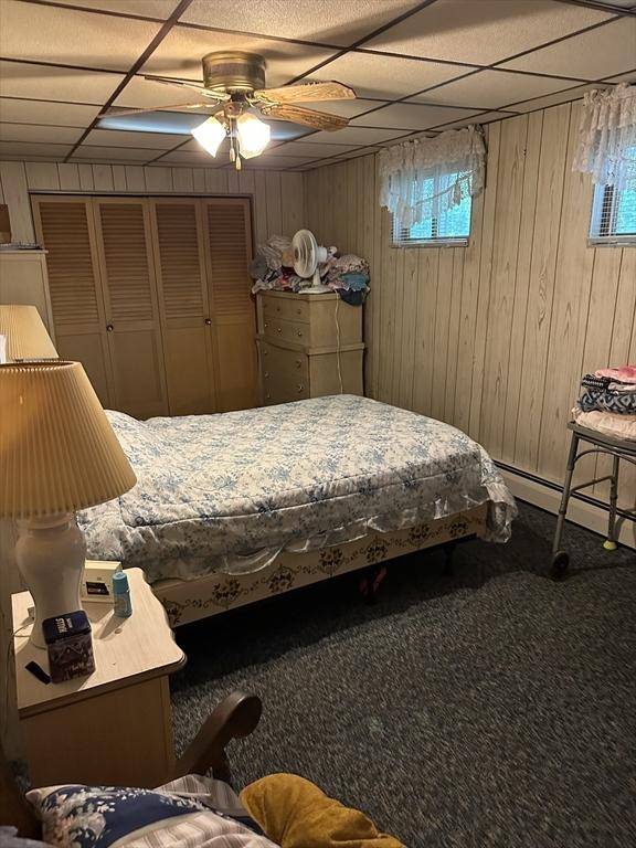 9 Coburn Ave, Worcester, MA 01604 - bedroom with carpet, a paneled ceiling, wooden walls, and a baseboard radiator