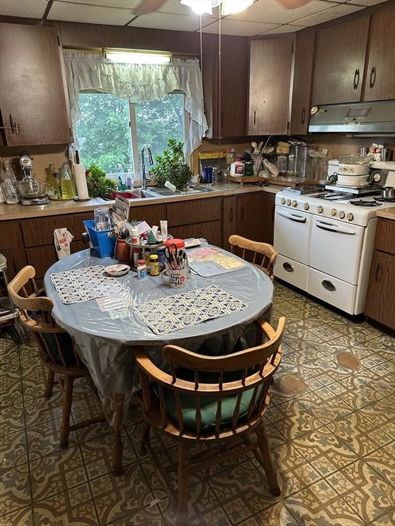 9 Coburn Ave, Worcester, MA 01604 - kitchen featuring range with two ovens, under cabinet range hood, a sink, a drop ceiling, and light countertops