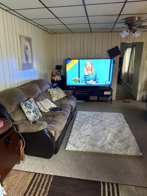 9 Coburn Ave, Worcester, MA 01604 - living area featuring wood walls, a drop ceiling, and a ceiling fan