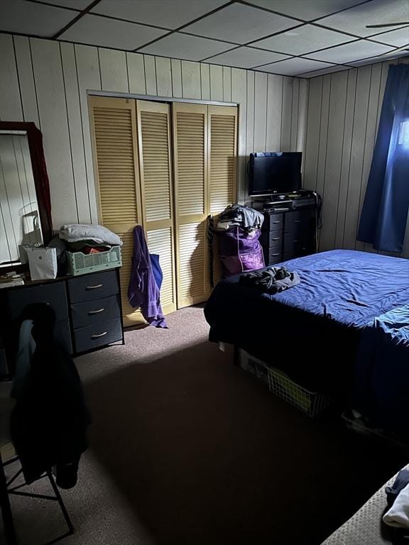 9 Coburn Ave, Worcester, MA 01604 - carpeted bedroom featuring a drop ceiling, wood walls, and a closet