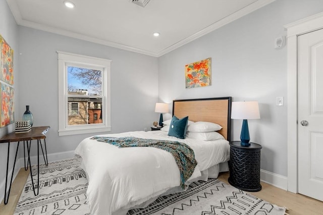 bedroom with ornamental molding, recessed lighting, baseboards, and wood finished floors