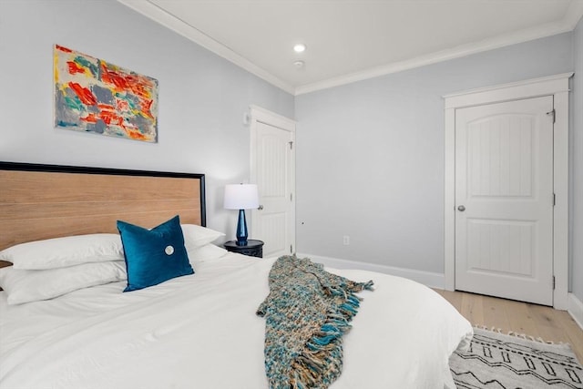 bedroom featuring ornamental molding, recessed lighting, light wood-style floors, and baseboards