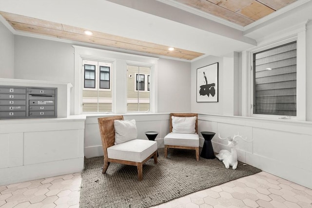 living area with a wainscoted wall, ornamental molding, mail area, a decorative wall, and recessed lighting