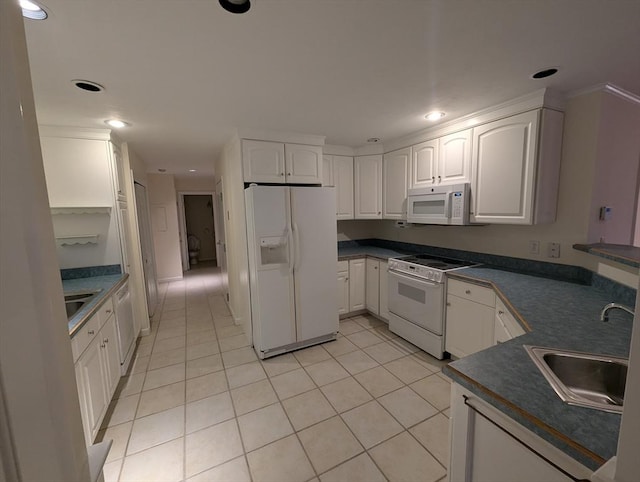 kitchen featuring sink, white appliances, light tile patterned floors, and white cabinets