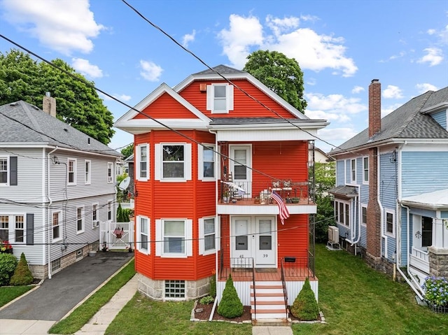 39-41 Ryan St, New Bedford, MA 02740 - view of front of home with a balcony, a gate, and asphalt driveway