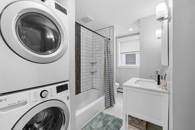 39-41 Ryan St, New Bedford, MA 02740 - bathroom with stacked washer and clothes dryer, vanity, shower / bath combination with curtain, baseboard heating, and recessed lighting