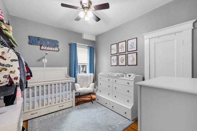 39-41 Ryan St, New Bedford, MA 02740 - bedroom featuring wood finished floors, a ceiling fan, and a nursery area