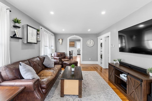 39-41 Ryan St, New Bedford, MA 02740 - living area featuring estacked washer and dryer, arched walkways, recessed lighting, and light wood finished floors