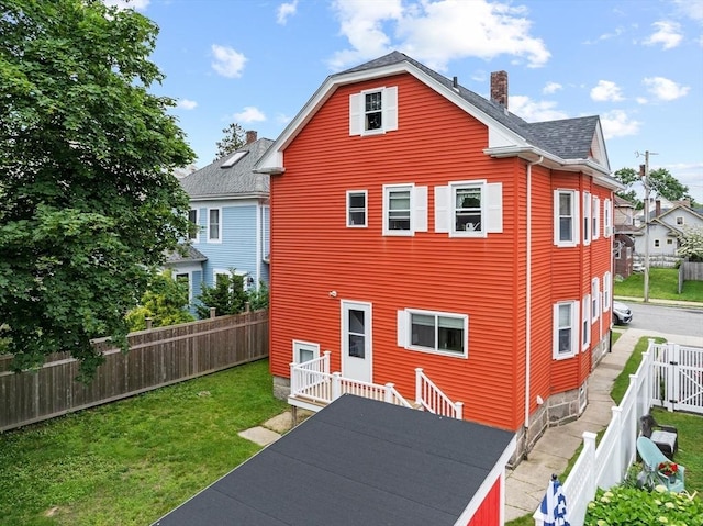 39-41 Ryan St, New Bedford, MA 02740 - rear view of property with a chimney, a fenced backyard, and roof with shingles