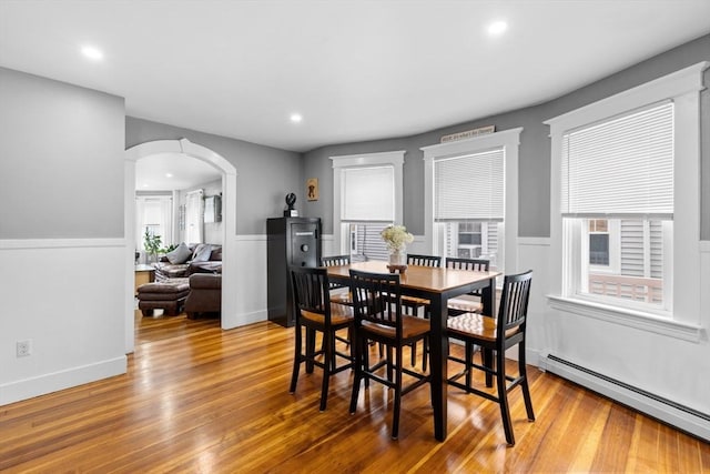 39-41 Ryan St, New Bedford, MA 02740 - dining room featuring a baseboard radiator, arched walkways, a wainscoted wall, wood finished floors, and recessed lighting