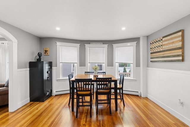 39-41 Ryan St, New Bedford, MA 02740 - dining space featuring baseboard heating, arched walkways, light wood-type flooring, wainscoting, and recessed lighting