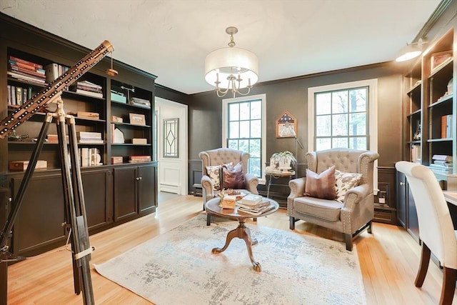 13 Bogastow Cir, Millis, MA 02054 - living area with ornamental molding, light wood-type flooring, a chandelier, and baseboard heating