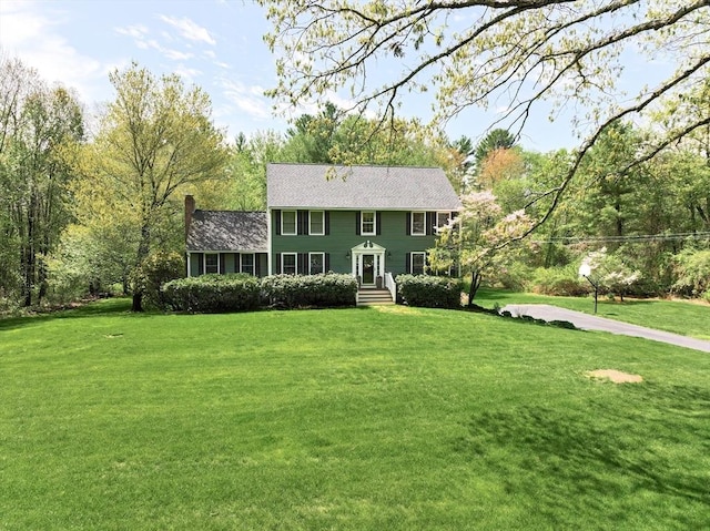 13 Bogastow Cir, Millis, MA 02054 - colonial home with a front lawn and a chimney