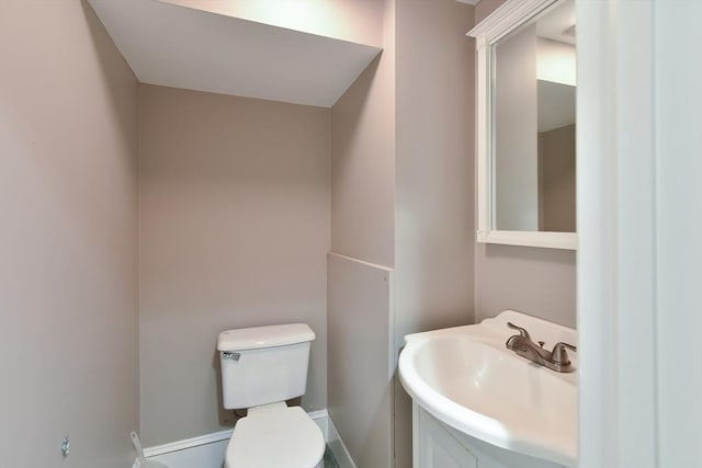 bathroom with toilet and a sink