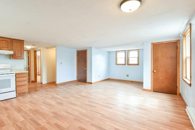 interior space with baseboards, light countertops, white range with electric cooktop, under cabinet range hood, and light wood-style flooring