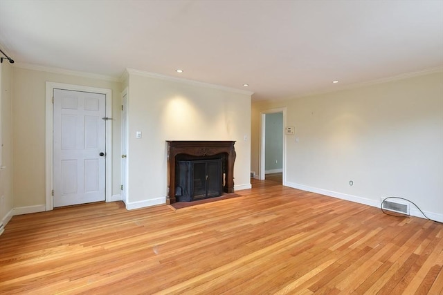 unfurnished living room featuring baseboards, light wood-style floors, crown molding, recessed lighting, and a fireplace with flush hearth