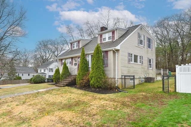 view of home's exterior with a chimney, a lawn, central AC, fence, and a shingled roof